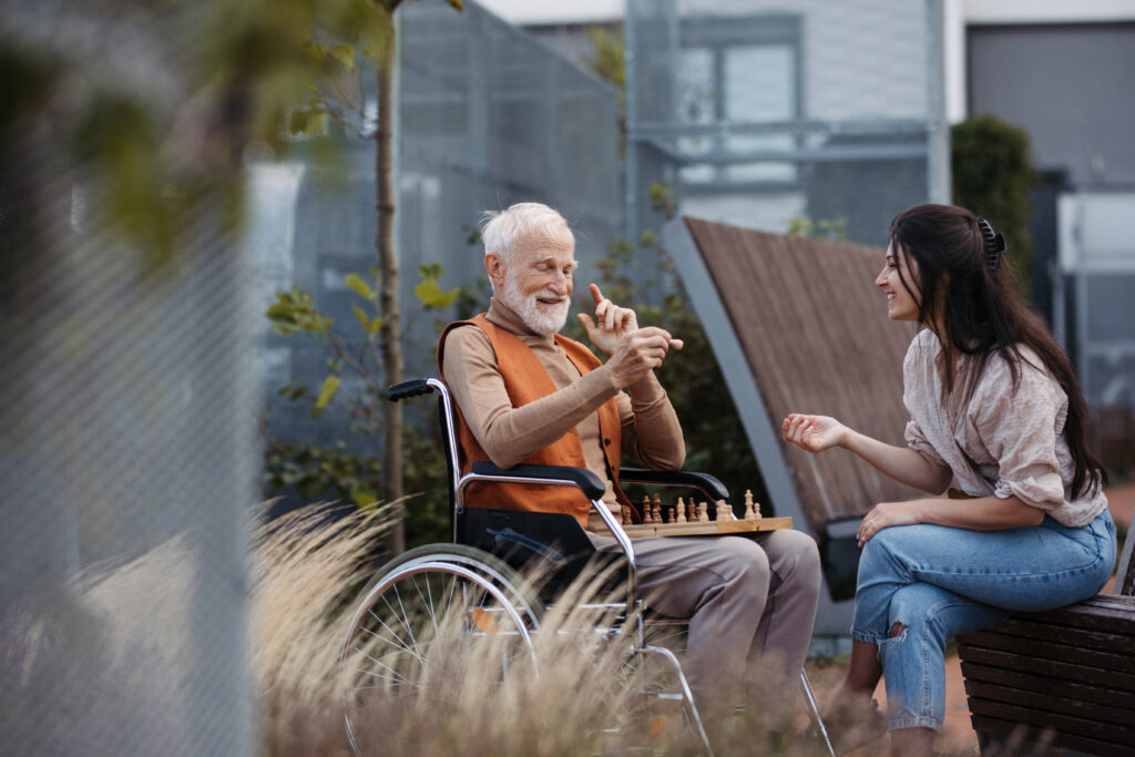 Older person spends time outside with a caregiver